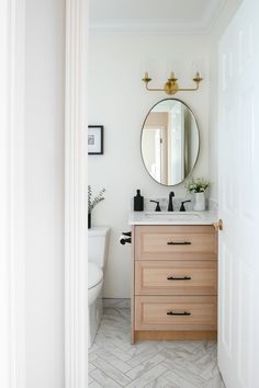 a bathroom with a sink, mirror and toilet