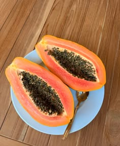 two pieces of papaya on a blue plate