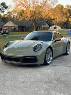 a silver sports car parked in a driveway