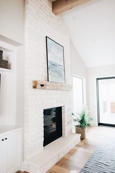 a living room filled with furniture and a flat screen tv mounted on a wall above a fireplace