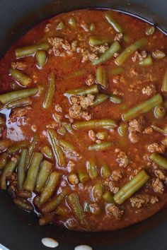 a pot filled with green beans and meat