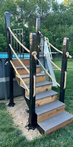 a set of stairs made out of wood and rope next to an above ground swimming pool