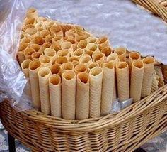 a basket filled with rolls sitting on top of a table