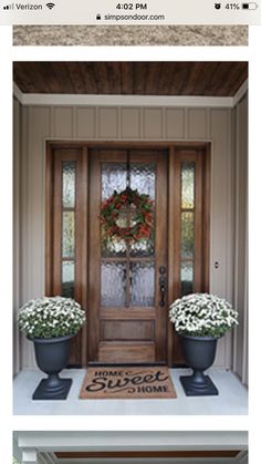 the front door is decorated with wreaths and flowers