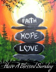 a rock stack with the words faith, hope and love painted on it in front of a sunset