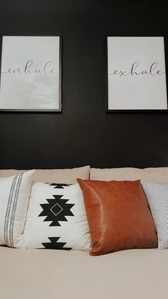 two framed pictures hang on the wall above a bed with white linens and pillows