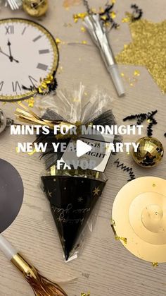 new year's eve party decorations with gold and black confetti, champagne flutes, clock