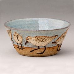 a ceramic bowl with birds painted on it