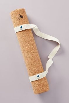 a cork yoga mat with a white ribbon tied around it