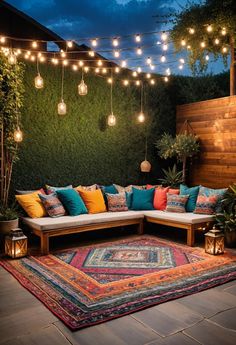 an outdoor seating area with lights strung above it and rug on the ground in front