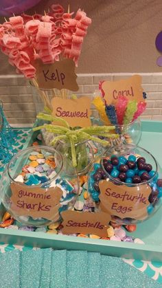 a table topped with lots of candy and candies on top of a blue tray