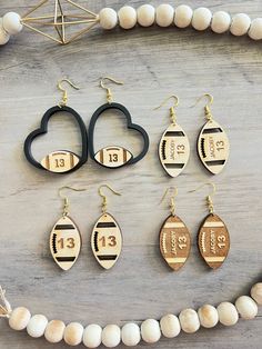 a necklace and earring set with numbers on it, including two heart shaped earrings