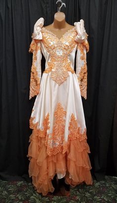 Vintage 1970s Victorian Style Princess Ruffled White w Orange Lace & Pearl Tiered Antique Edwardian Style Dress w Tulle Accents Wedding Dress.  Dress is in good condition, a couple of very tiny imperfections - see pics. Dress has a flowing, tiered skirt for a flattering fit and a white full underskirt, prominent ruffle lace and pearl detailing on bodice, sweetheart neck, and a back zipper closure.   Measurements: waist 28, bust 38, sleeve shoulder to cuff 24, sleeve pit to cuff 17, length in front 57, length in back 68, shoulder to shoulder 16 inches. Edwardian Style Dress, Edwardian Fashion Dresses, Edwardian Style, Edwardian Fashion, Tier Skirt, Sweetheart Neck, Tiered Skirt, Victorian Style, Vintage 1970s