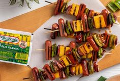 the skewers are covered with grilled vegetables and ketchup, along with a packet of mustard