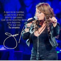 a woman singing into a microphone with an autographed photo on the back ground