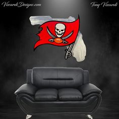 a living room with a couch, chair and pirate flag wall decal