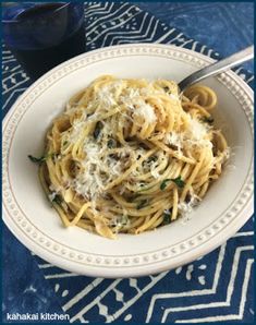 a white bowl filled with pasta and cheese