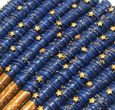 some blue and gold stars are on top of each other in the air with brown sticks sticking out of them