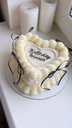 a heart shaped birthday cake on a table