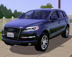 a blue car parked in front of a white picket fence