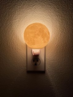 a light that is on the side of a wall with a small lamp in it