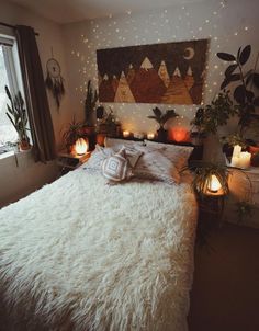 an instagram photo of a bed with white fur on it and some candles in the corner