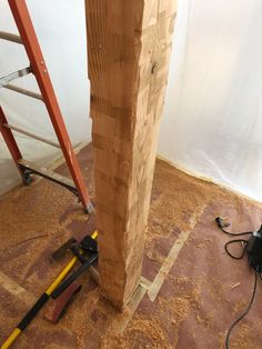 a wooden post is being worked on with tools