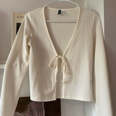 Fitted White Ribbed Cardigan With Tie Front Detail. Hits Above Waist, Never Worn, In Excellent Condition. Fitted Long Sleeve H&m Cardigan, H&m Fitted Long Sleeve Cardigan, H&m V-neck Sweater For Spring, H&m V-neck Spring Cardigan, White Ribbed Cardigan For Spring, H&m V-neck Cardigan For Spring, Casual H&m V-neck Cardigan, Cardigan With Tie, Y2k Cardigan