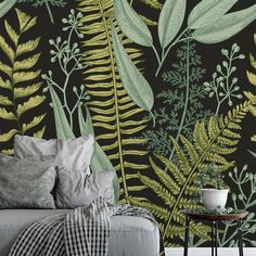 a bedroom with green leaves and plants on the wall, in front of a bed