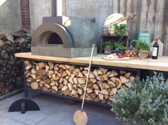 an outdoor wood burning oven on top of a table