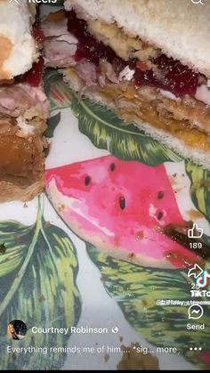 a close up of a sandwich on a plate with watermelon and other foods