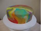 a multicolored cake sitting on top of a white plate