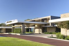 a large building with lots of windows on the side of it and grass in front of it