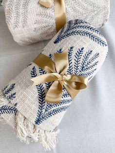 two wrapped presents with gold ribbons on them