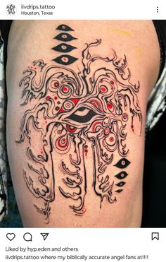 an artistic tattoo design on the back of a woman's thigh, with red and black ink