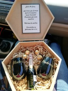 two wine glasses in a wooden box with the words madri on it and some corks