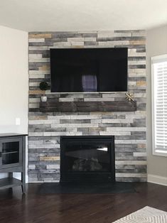 a fireplace with a flat screen tv mounted on it's wall above the fire place