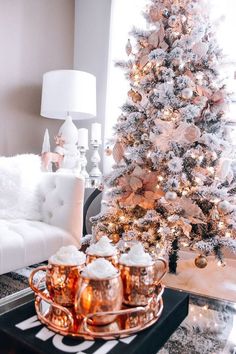 a white christmas tree with pink and gold decorations