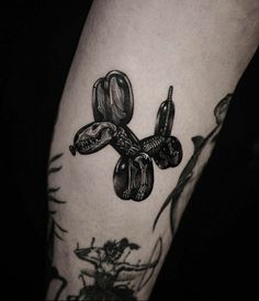 a black and white photo of a person's arm with tattoos on it