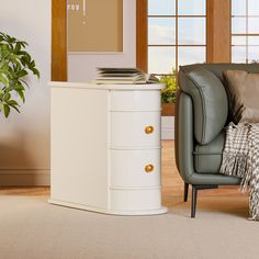 a chair sitting next to a white dresser in a living room