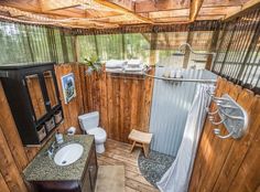 a bathroom with wood paneling and wooden floors