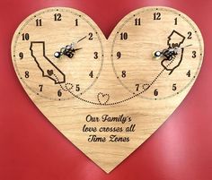 a wooden heart shaped clock with the words our family's love crosses all times zones