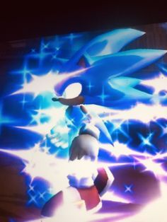 sonic the hedgehog is in front of a large screen with blue and white lights