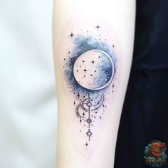 a woman's arm with a crescent and stars tattoo on it