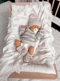 a baby doll is laying in a crib