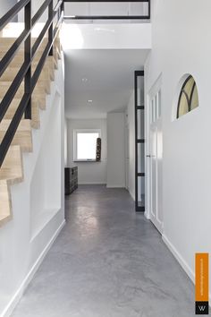 an empty hallway with stairs leading up to the second floor