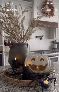 a kitchen counter top with halloween decorations on it and candles in front of the sink