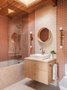 a bathroom with a sink, mirror and bathtub in it's center area