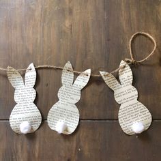 some paper bunnies are hanging on a string