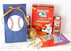 an assortment of snacks including apples, crackers and candy